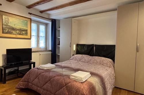 a bedroom with a bed with two towels on it at Torretta International in Trieste