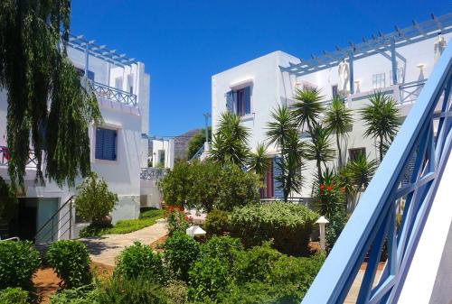 a view of a white building with trees and plants at Cybele Apartments in Makry Gialos