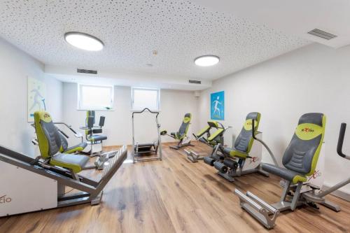 a gym with treadmills and chairs in a room at Camping Seehof in Kramsach