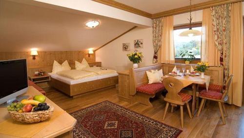 a hotel room with a bed and a dining room at Camping Seehof in Kramsach