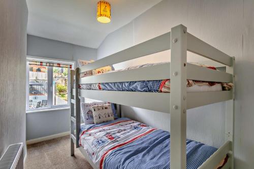 a bunk room with two bunk beds and a bed at 3 Bed in Dawlish oc-c29669 in Dawlish