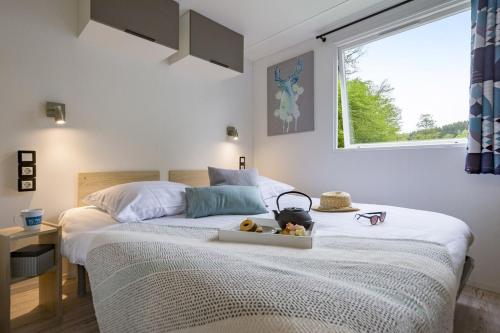 a bedroom with a bed with a tray with teddy bears on it at Cottage 5p 2Bdrms 16110 in Grupont