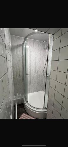 a shower with a glass door in a bathroom at 36 flat 1 - Room 1 in Swansea