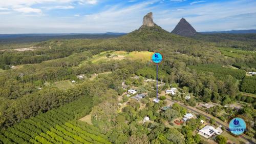 an aerial view of a vineyard with a mountain at Glass House Mountains Retreat Sunshine Coast in Glass House Mountains