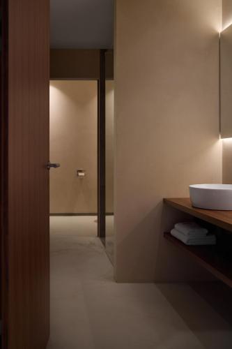 a bathroom with a sink and a mirror at Saltus, Small Luxury Hotels SLH in San Genesio Atesino