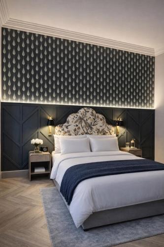 a bedroom with a large bed with a black wall at The Tholsel Bar and Townhouse Kilkenny in Kilkenny