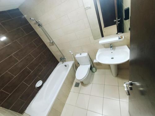 a bathroom with a toilet and a sink and a bath tub at ApartHotel Rooms in Ajman