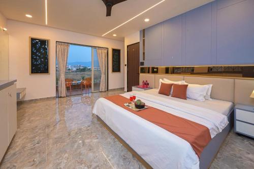 a bedroom with a large bed in a room at Vrundavan Villa Lonavala in Malavli