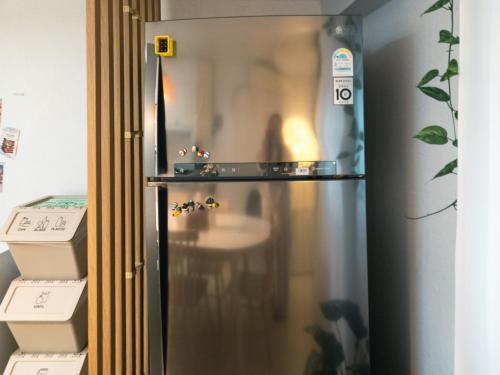 a stainless steel refrigerator in a room at Bandal Stay in Daegu in Daegu