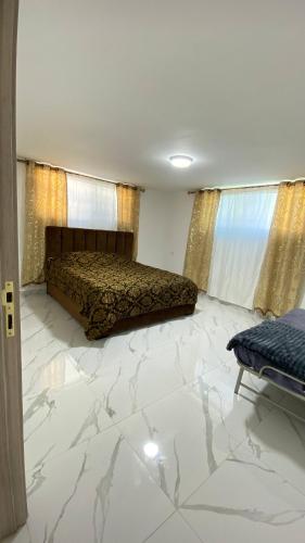 a bedroom with a bed and a marble floor at W3 property in Kerak