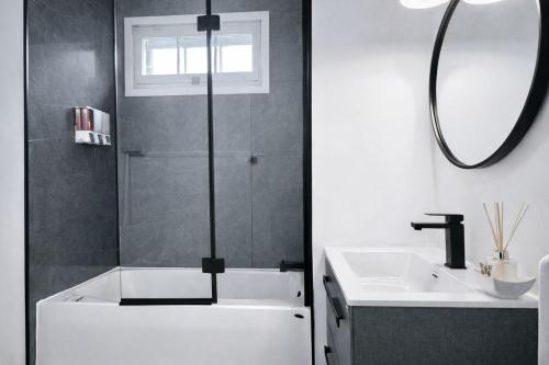 a bathroom with a bath tub and a sink at The Royal d'Antan 8 people Parking in Quebec City