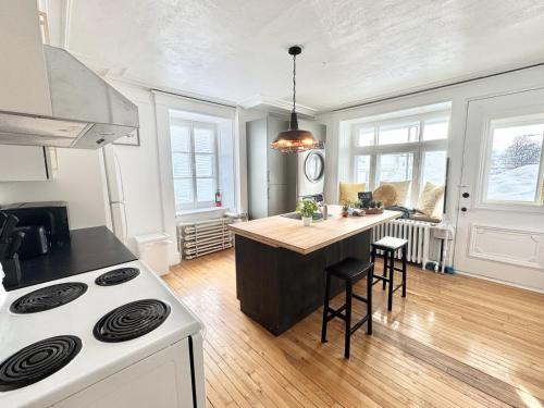a kitchen with a stove and a counter top at The Royal d'Antan 8 people Parking in Quebec City