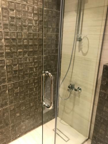 a shower stall with a glass door with a shower at DAMAC Tower Amman boulevard برج داماك - عمان البوليفارد العبدلي in Amman