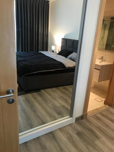 a mirror reflection of a bed in a bedroom at DAMAC Tower Amman boulevard برج داماك - عمان البوليفارد العبدلي in Amman
