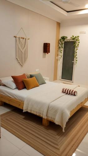 a bedroom with a large bed in a room at Newsy Inn in Hithadhoo