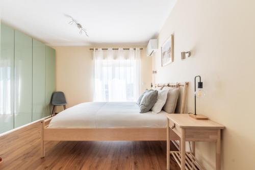 a bedroom with a bed and a window at Ericeira Beach Apartment in Ericeira