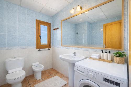 a bathroom with a sink toilet and a mirror at Ca na Lluny in Artá