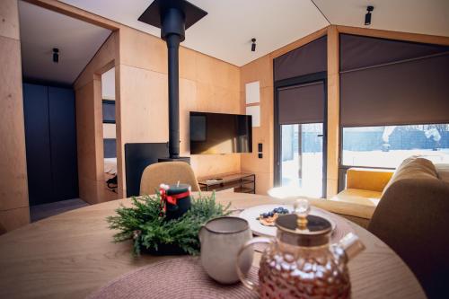 a room with a table and a living room at La Villa Chalet and Spa in Polyana