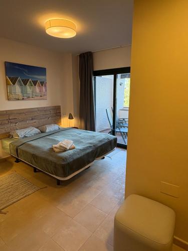 a bedroom with a bed and a chair in it at Sonne - Golf - 4Pers - Komfort - Apartments in Fuente-Álamo de Murcia