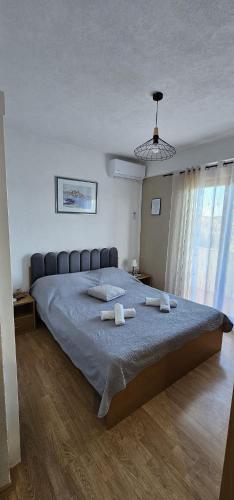 a bedroom with a large bed with towels on it at Apartments Sime in Sukošan