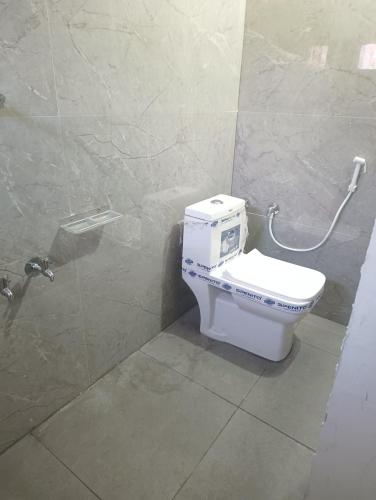 a bathroom with a toilet in a stall at Hotel Homestay-Bhimavaram in Bhīmavaram
