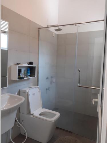 a bathroom with a shower and a toilet and a sink at Sathmani One in Nikawatawana