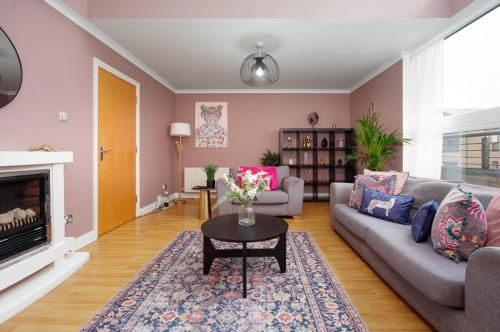 a living room with a couch and a table at 5 Bed Finnieston SkyHigh Duplex with Parking in Glasgow