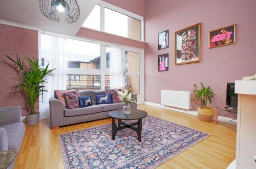 a living room with a couch and a table at 5 Bed Finnieston SkyHigh Duplex with Parking in Glasgow