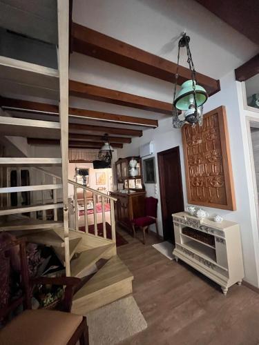 a living room with wooden stairs and a stair case at Stone house Anogeia in Anogeia