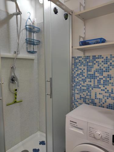 a bathroom with a washing machine and a shower at La Tana in Formia