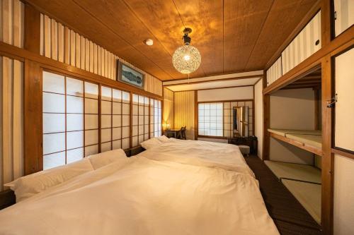 a large white bed in a room with windows at Soresta INN Shinozaki in Tokyo