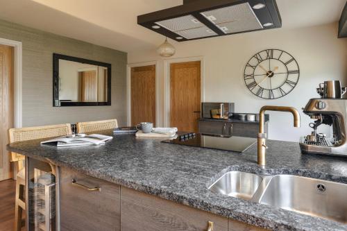 a kitchen with a sink and a counter top at Scar View - Getaway for Two - Ridgestone in Underbarrow