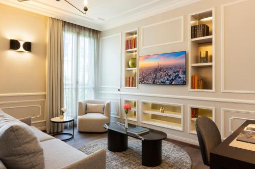 a living room with a couch and a table at La Clef Tour Eiffel Paris by The Crest Collection in Paris