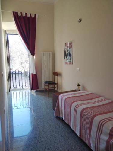 a bedroom with a bed and a sliding glass door at Il Pettirosso alloggio turistico panoramico in Narni