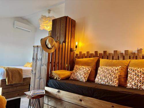 a couch with pillows on it in a room at Fianca l'Osso in Belvédère