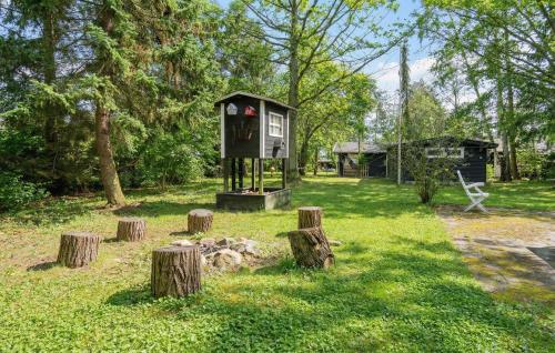 a bird house in the middle of a yard at 2 Bedroom Beautiful Home In Orø in Orø