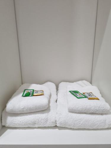 two stacks of towels sitting on a shelf at Mirasoles Suites in Monte Grande