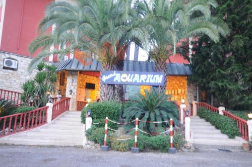 a building with a palm tree in front of it at Grand Aquarium in Marmaris