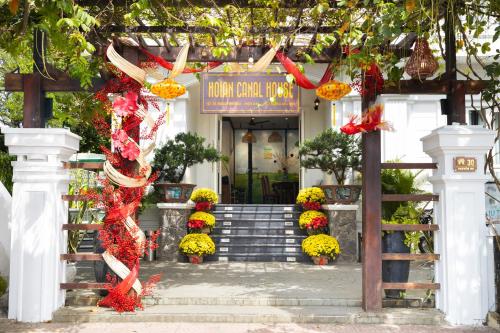 a entrance to a building with a bunch of flowers at Hoi An Canal House Riverside By Haviland in Hoi An