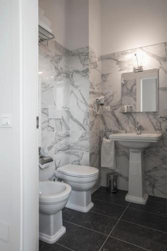 a bathroom with a toilet and a sink at 7Florence in Florence