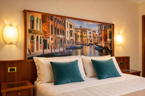 a bedroom with a painting of a canal at Hotel President Venezia in Mestre