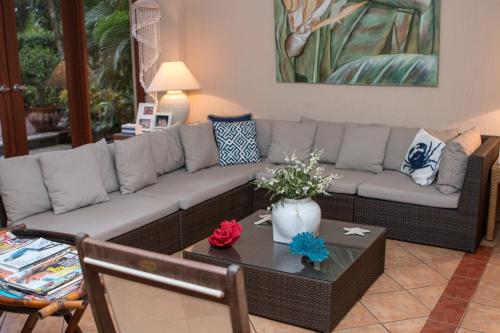 a living room with a couch and a table at Bahia Pez Vela Resort in Ocotal