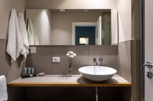 a bathroom with a sink and a mirror at Villa Masetta - Luxury Suites in Mondello