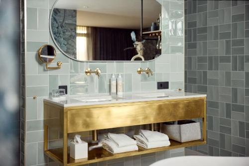a bathroom with a sink and a mirror at Van der Valk Hotel Melle - Osnabrück in Melle