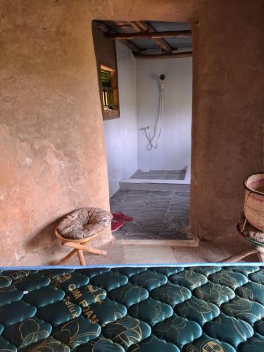 a bathroom with a shower and a turtle laying on the floor at Paradise Resort in Chabahinga