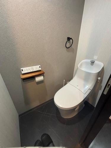 a bathroom with a white toilet and a scale at HOTTOSTAYHoNMACHI in Nagoya