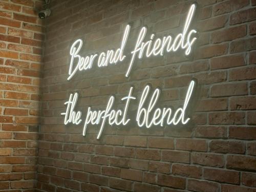 a neon sign on a brick wall at Siedlisko Nielbark in Nielbark