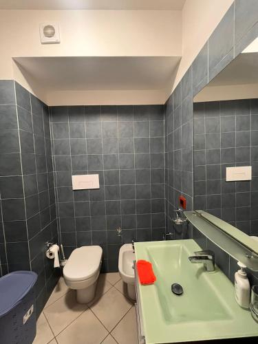 a bathroom with a toilet and a green sink at La terrazza sul mare in Messina