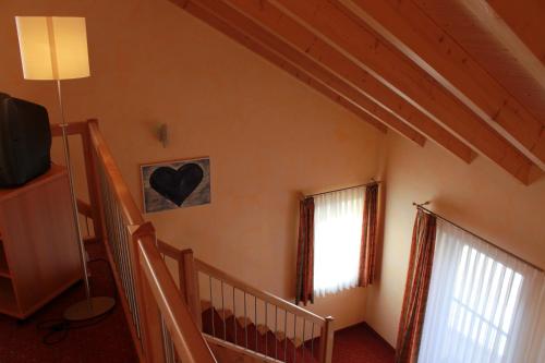 a living room with a staircase and a window at Hotel-Restaurant Fröhlich in Kaiserslautern