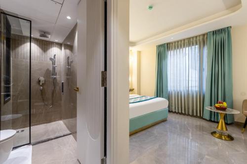 a bathroom with a shower and a toilet and a sink at Hotel The Janak By Shanti Near New Delhi Train Station , New Delhi in New Delhi